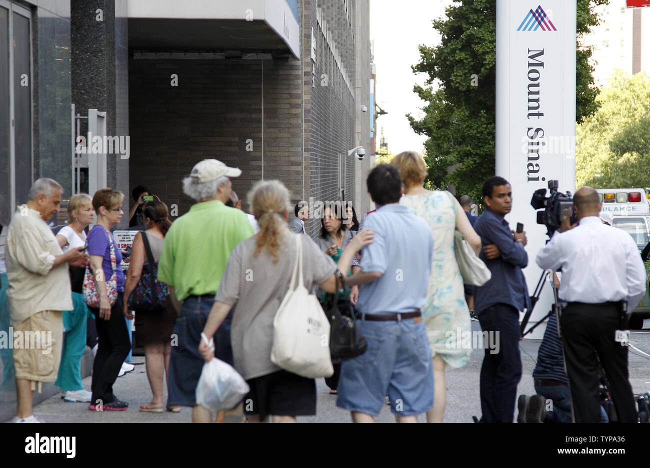 People Walk By Mount Sinai Hospital In New York City On