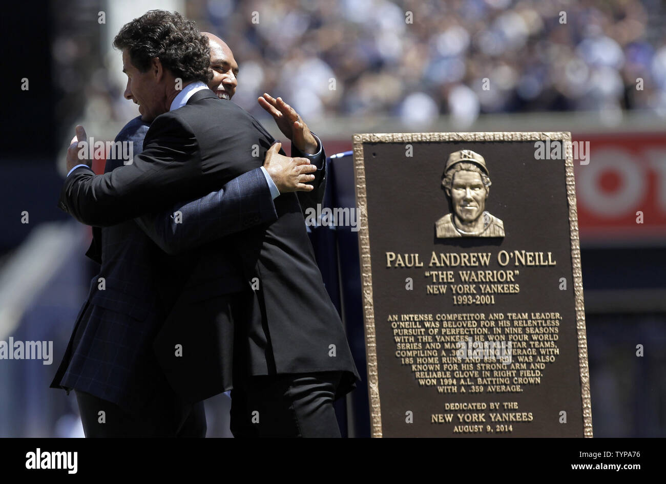 Retired New York Yankees players Mariano Rivera and Paul O'Neill hug on the field after a ceremony inducting O'Neill into Monument Park with a new plaque before the game against the Cleveland Indians at Yankee Stadium in New York City on August 9, 2014. Monument Park is an open-air museum located at the new Yankee Stadium containing a collection of monuments, plaques, and retired numbers honoring distinguished members of the New York Yankees.    UPI/John Angelillo Stock Photo