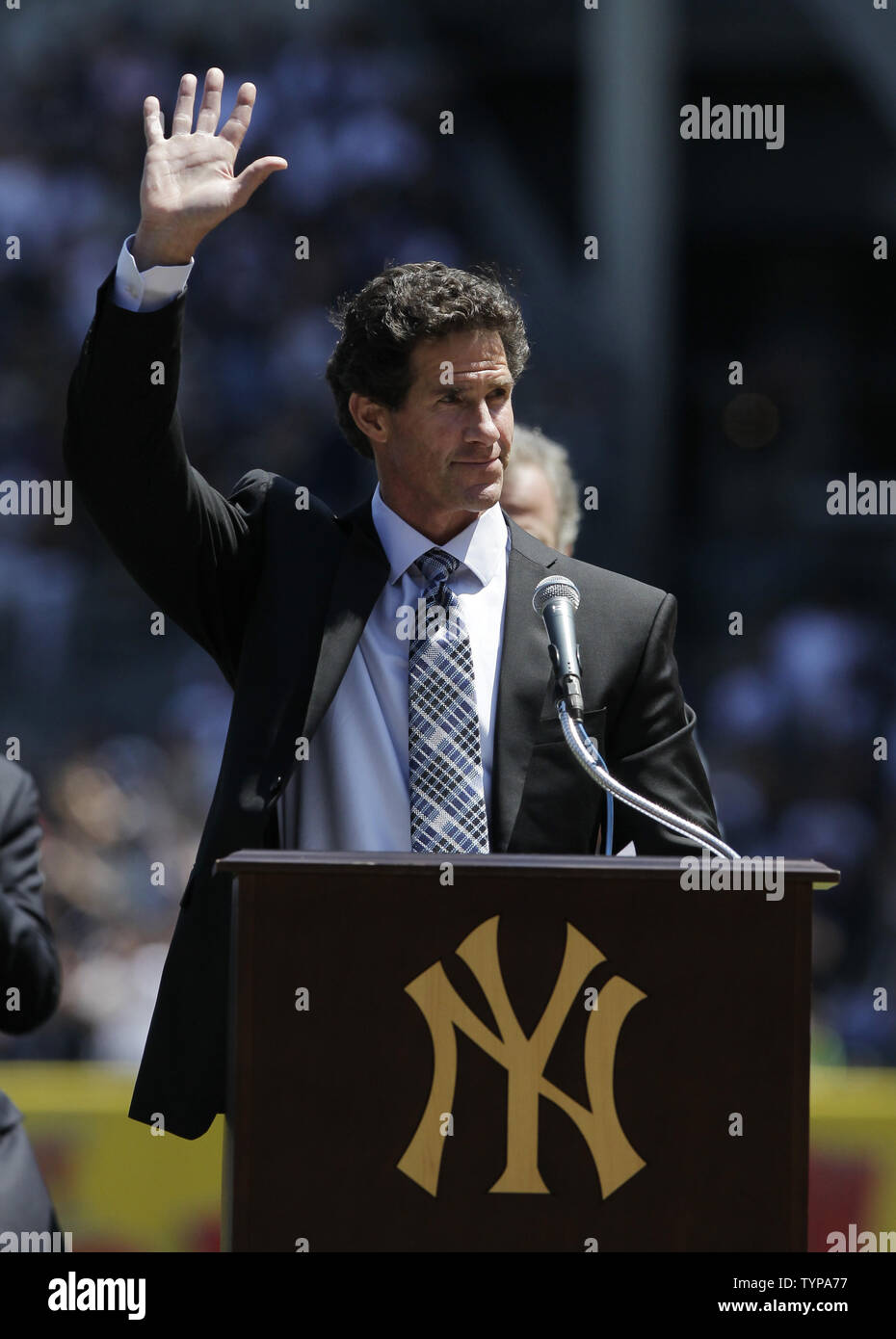 Retired New York Yankees player Paul O'Neill waves to fans after speaking at a ceremony inducting O'Neill into Monument Park with a new plaque before the game against the Cleveland Indians at Yankee Stadium in New York City on August 9, 2014. Monument Park is an open-air museum located at the new Yankee Stadium containing a collection of monuments, plaques, and retired numbers honoring distinguished members of the New York Yankees.    UPI/John Angelillo Stock Photo