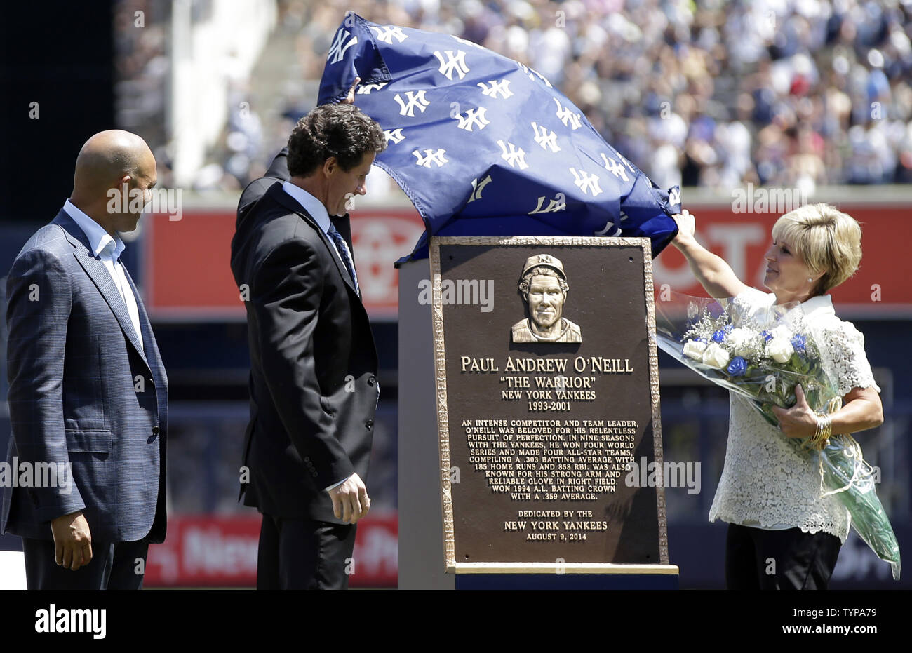 Retired New York Yankees players Mariano Rivera watches Paul O'Neill and his wife Nevalee unveil a plaque at a ceremony inducting O'Neill into Monument Park before the game against the Cleveland Indians at Yankee Stadium in New York City on August 9, 2014. Monument Park is an open-air museum located at the new Yankee Stadium containing a collection of monuments, plaques, and retired numbers honoring distinguished members of the New York Yankees.    UPI/John Angelillo Stock Photo