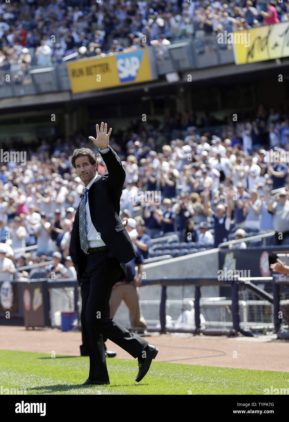 Retired New York Yankees player Paul O'Neill waves to fans before speaking at a ceremony inducting O'Neill into Monument Park with a  new plaque before the game against the Cleveland Indians at Yankee Stadium in New York City on August 9, 2014. Monument Park is an open-air museum located at the new Yankee Stadium containing a collection of monuments, plaques, and retired numbers honoring distinguished members of the New York Yankees.    UPI/John Angelillo Stock Photo