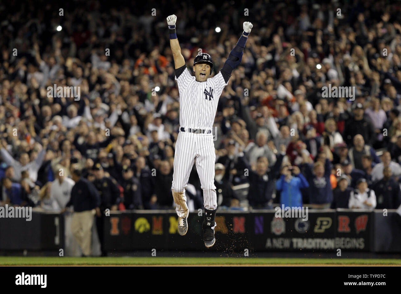 New York Yankees Derek Jeter leaps and celebrates after hitting a walk off game winning single in the bottom of the 9th inning against the Baltimore Orioles in Derek Jeter's final game ever at at Yankee Stadium in New York City on September 25, 2014. The Yankees defeated the Orioles6-5. Derek Jeter will end his MLB Hall Of Fame career with a 3-game series in Boston against the Red Sox this weekend.       UPI/John Angelillo Stock Photo