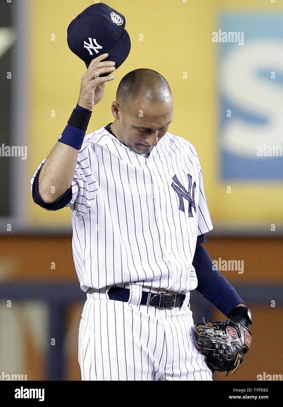 New York Yankees Derek Jeter tips his cap when fans chant his name