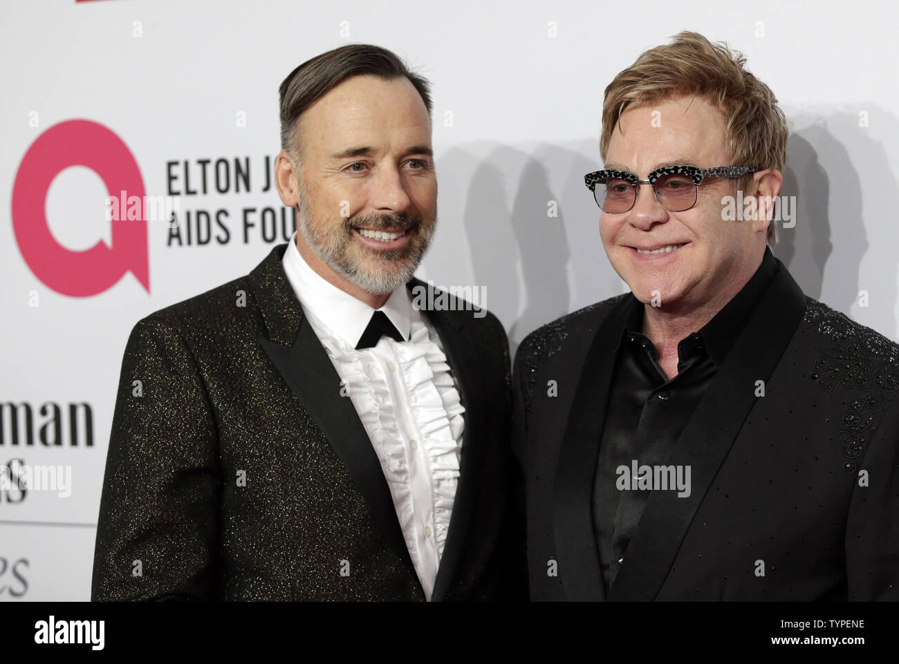 David Furnish and Elton John arrive on the red carpet at the Elton John