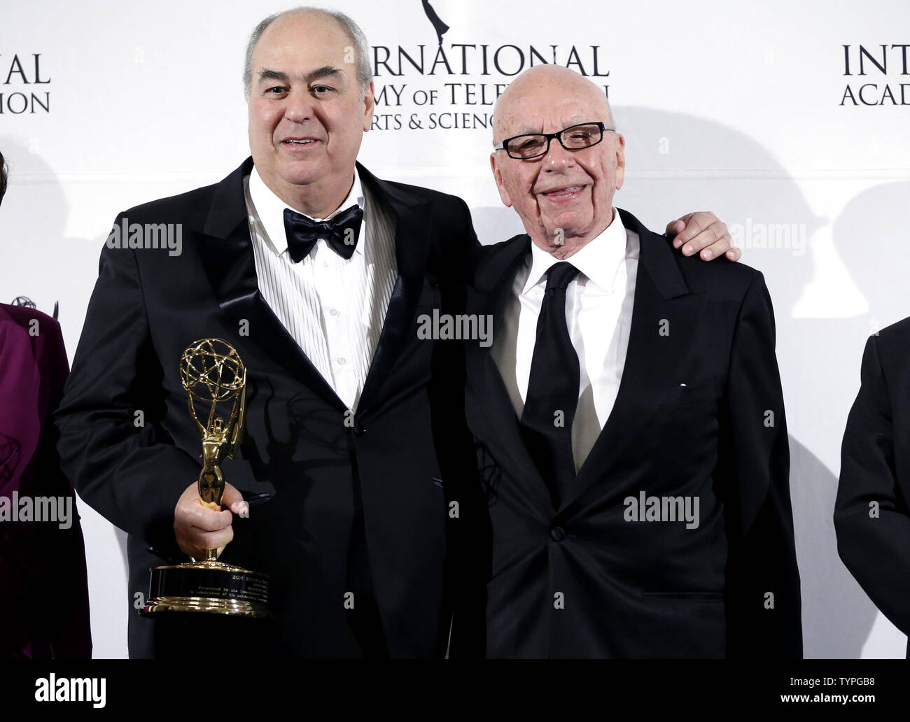 Roberto Irineu Marinho (L), Brazilian Chairman and CEO of Grupo Globo,  stands with businessman Rupert Murdoch when they arrive in the press room  at the 2014 International Academy Of Television Arts &
