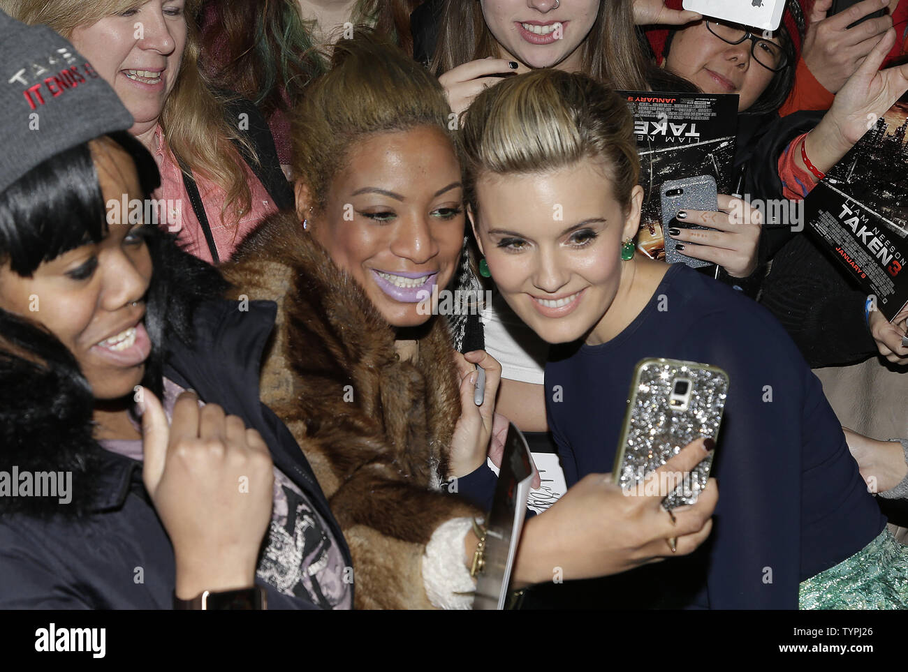 Maggie Grace takes a selfie with a fan when she arrives on the red carpet at the 'Taken 3' Fan Event Screening at AMC Empire 25 Theater in New York City on January 7, 2015.    Photo by John Angelillo/UPI Stock Photo