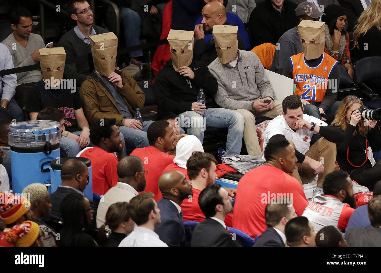 Five fans wear paper bags on their heads in the 4th quarter when the