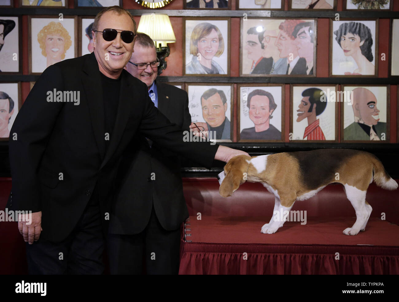 Designer Michael Kors pets Miss P, the Beagle from the Hound Group, the day  after Miss