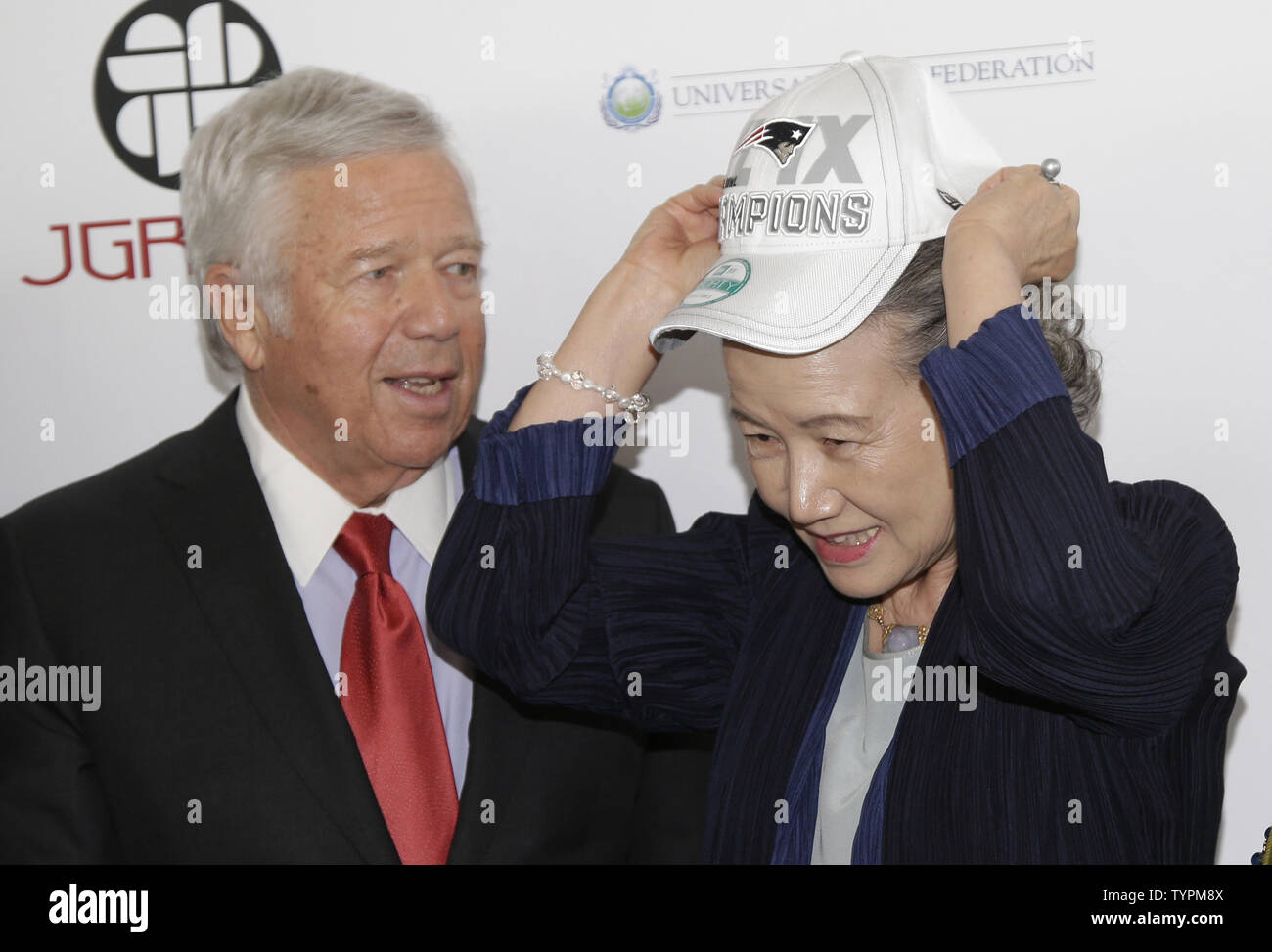 Chairman and CEO of the Kraft Group Robert Kraft watches wife of