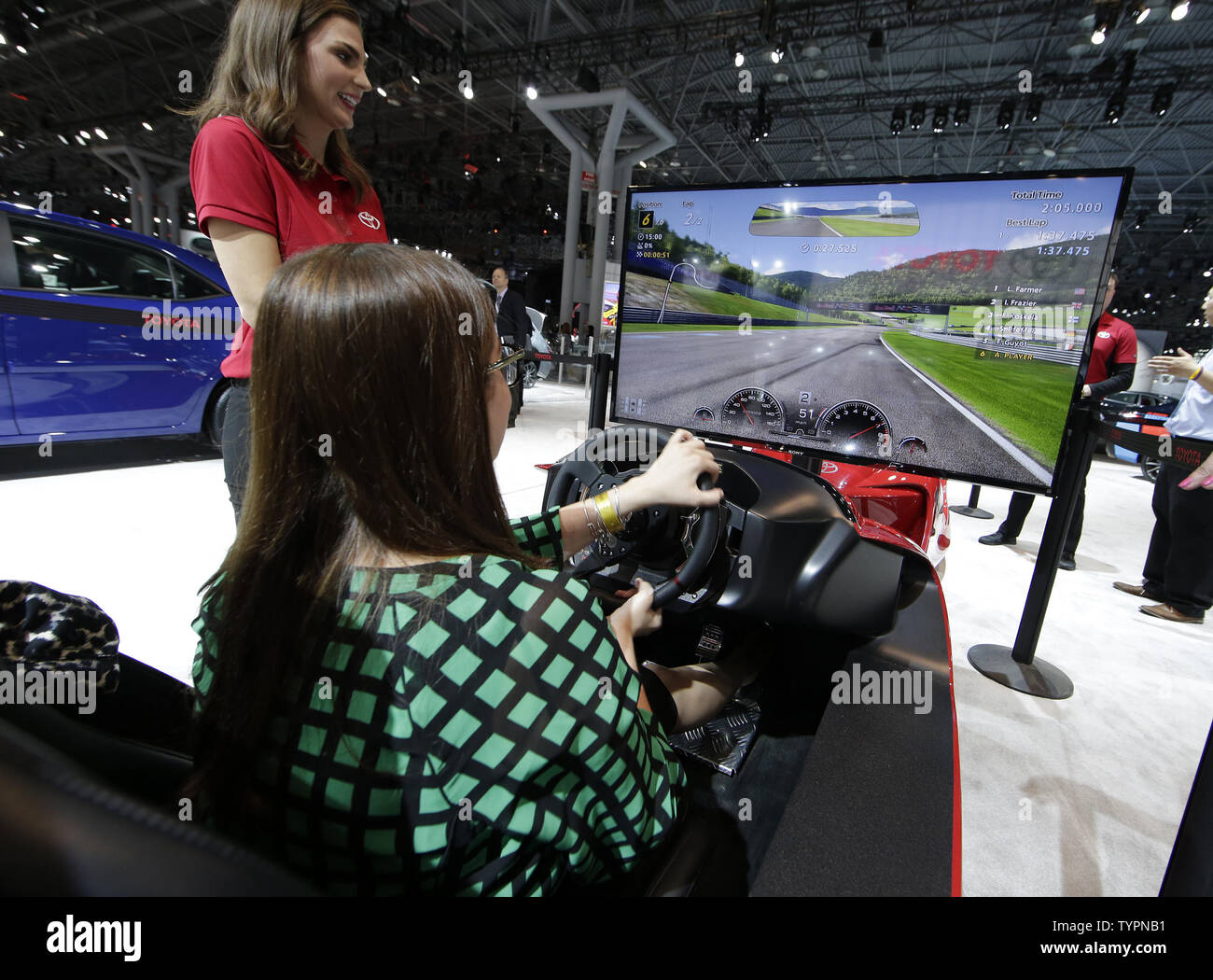 A girl drives a race car simulator at the 2015 New York International Auto Show in New York City on April 1, 2015. The first New York Auto Show was held in 1900 and it was the first auto show ever held in North America. About 1 million visitors are expected to attend the show.      Photo by John Angelillo/UPI Stock Photo