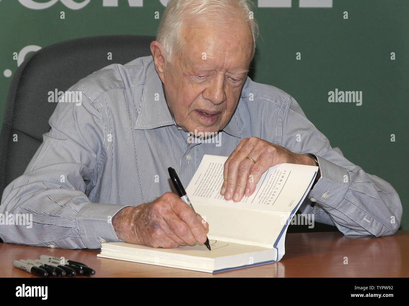 Former United States President Jimmy Carter signs copies of his book "A