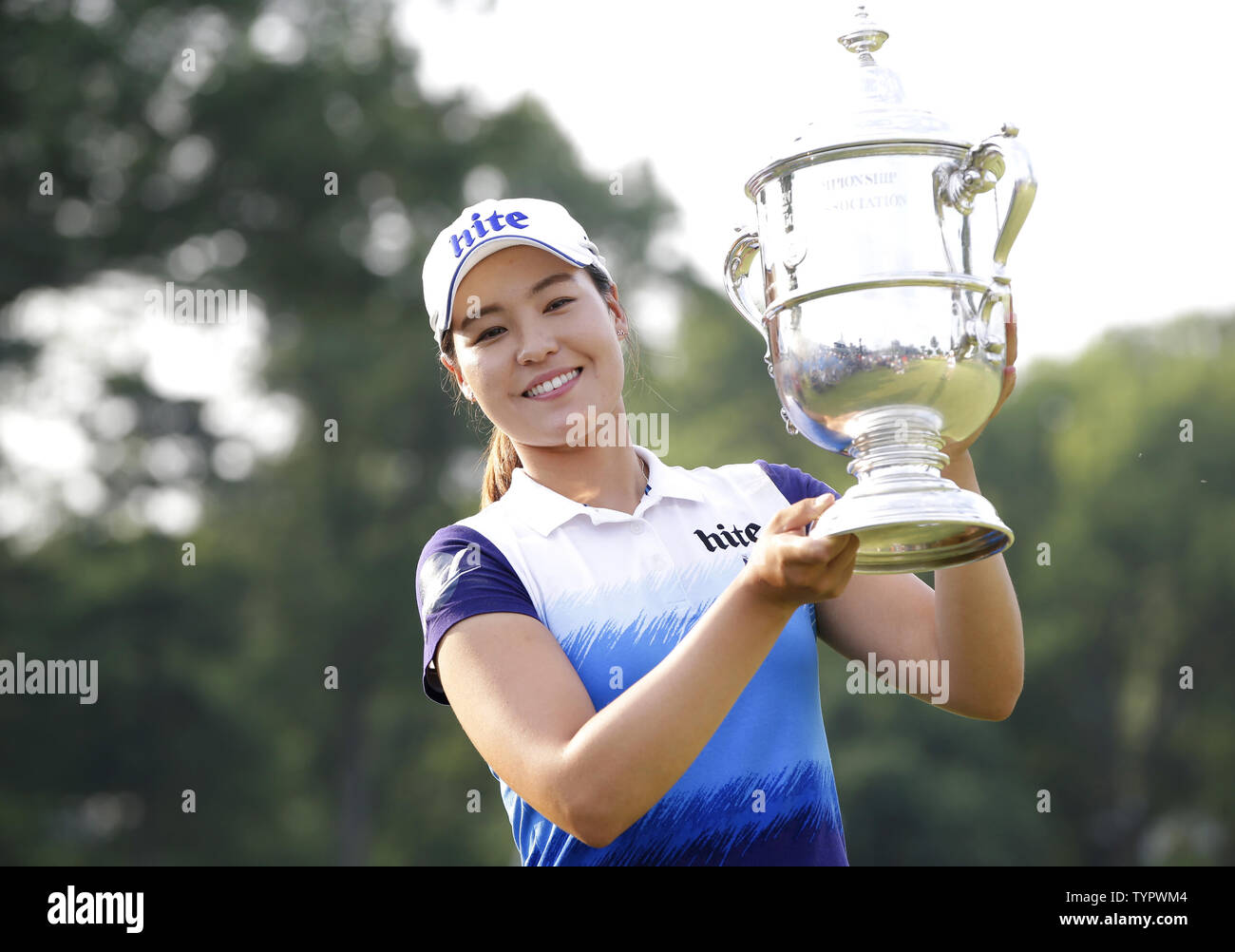 In Gee Chun of Korea holds up the championship trophy on the 18th green in the final round of the LPGA U.S. Women's Open Championship at Lancaster Country Club in Lancaster, PA on July 12, 2015. Chun wins the U.S. Women's Open and her first LPGA major championship with a score of 8 under par.     Photo by John Angelillo/UPI Stock Photo