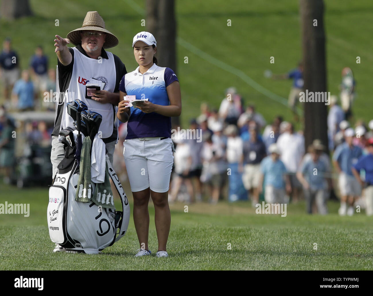 In Gee Chun of Korea stands with caddie Dean Herden in the rough on the 18th hole in the final round of the LPGA U.S. Women's Open Championship at Lancaster Country Club in Lancaster, PA on July 12, 2015. Chun wins the U.S. Women's Open and her first LPGA major championship with a score of 8 under par.     Photo by John Angelillo/UPI Stock Photo