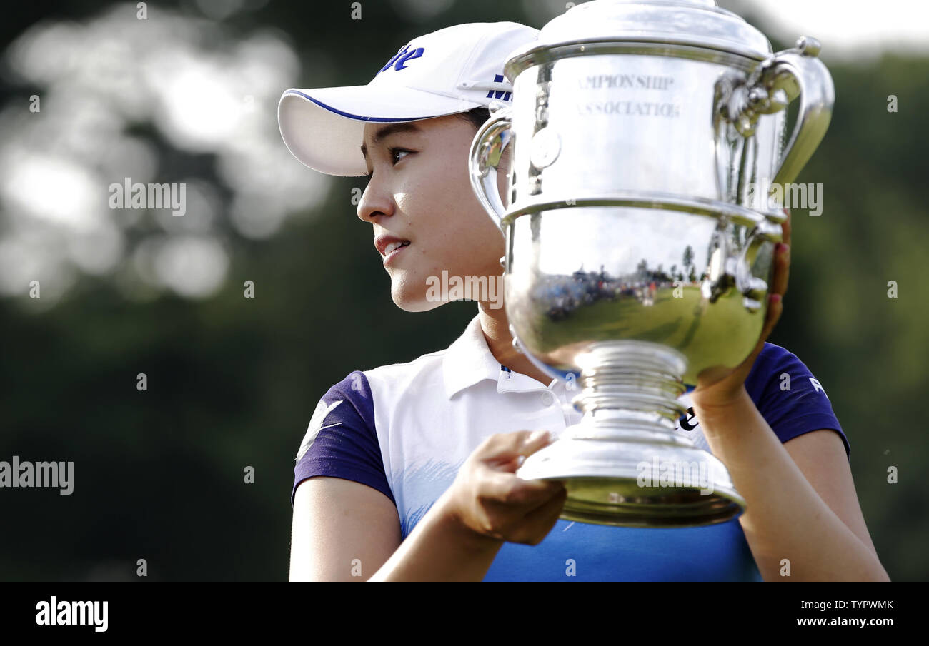 In Gee Chun of Korea holds up the championship trophy on the 18th green in the final round of the LPGA U.S. Women's Open Championship at Lancaster Country Club in Lancaster, PA on July 12, 2015. Chun wins the U.S. Women's Open and her first LPGA major championship with a score of 8 under par.     Photo by John Angelillo/UPI Stock Photo
