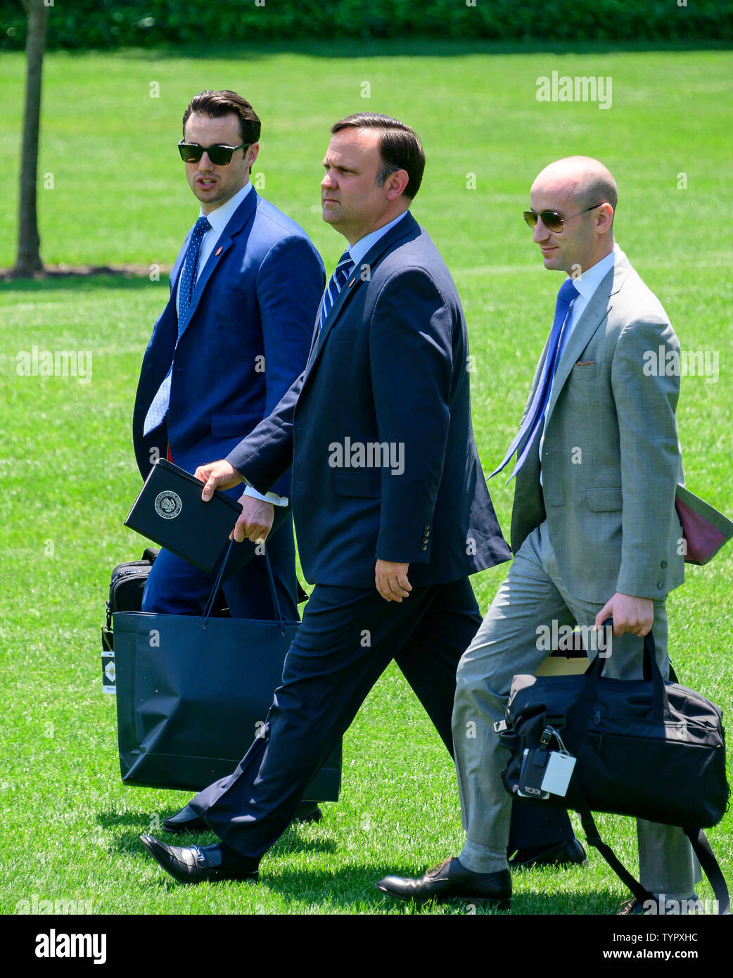 Washington, United States Of America. 26th June, 2019. From left to right: Deputy Assistant to the President for Operations and Personal Aide to the President Nicholas Luna, White House Director of Social Media Dan Scavino, Senior Advisor for Policy Stephen Miller follow United States President Donald J. Trump as he departs the South Lawn of the White House in Washington, DC en route to the G20 summit in Osaka, Japan on Wednesday, June 26, 2019.Credit: Ron Sachs/CNP | usage worldwide Credit: dpa/Alamy Live News Stock Photo