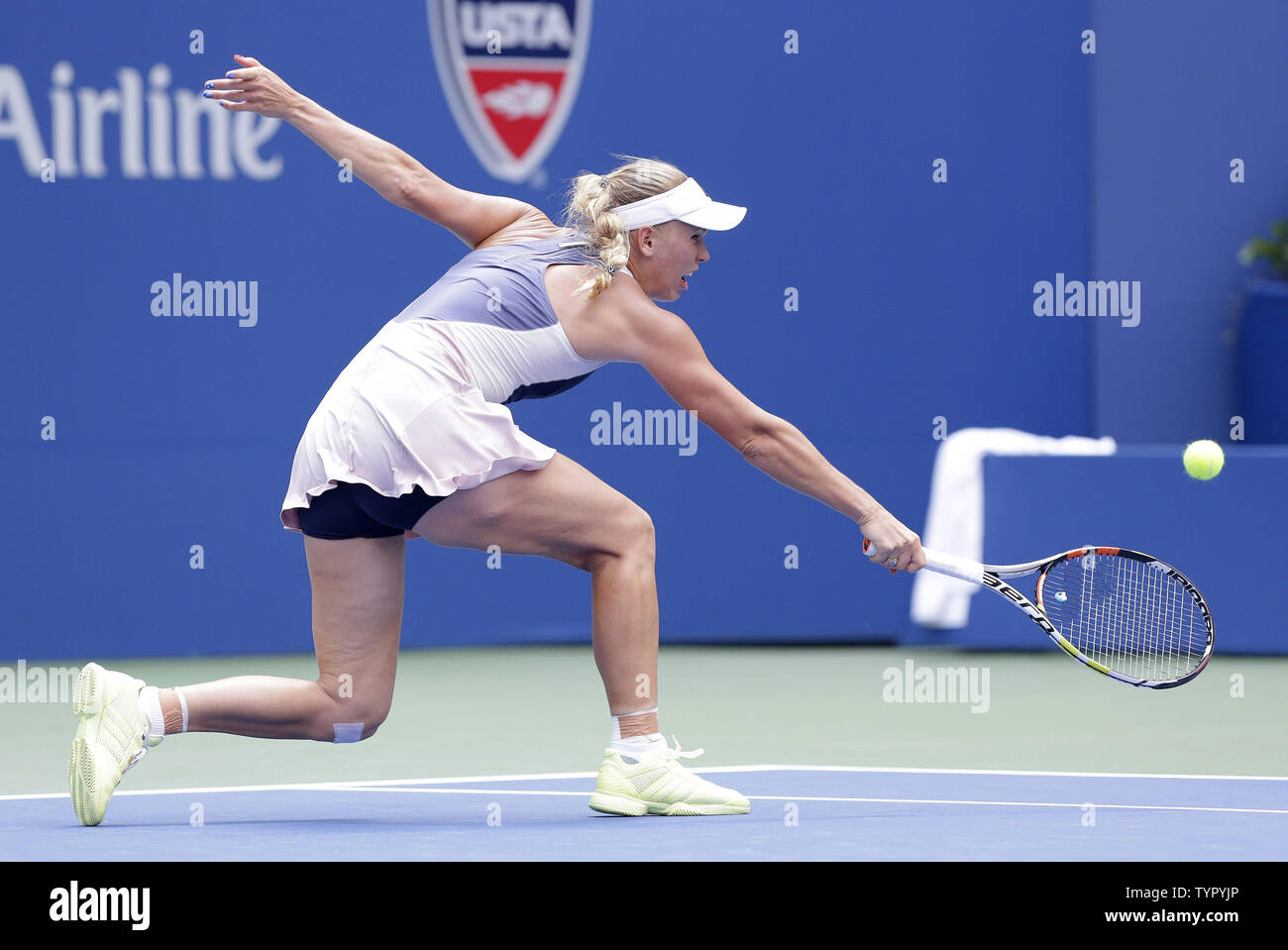 Caroline Wozniacki of Denmark hits a backhand to Jamie Loeb in their first round match in Arthur Ashe Stadium on day two at the US Open Tennis Championships at the USTA Billie Jean King National Tennis Center in New York City on September 1, 2015.      Photo by John Angelillo/UPI Stock Photo