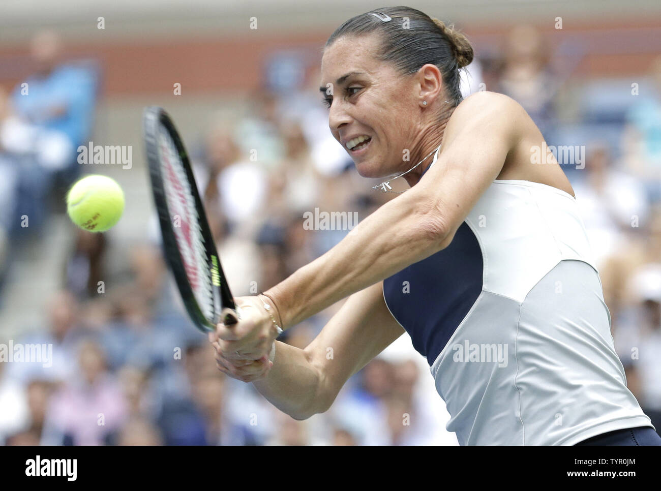 Flavia Pennetta of Italy hits a backhand to Roberta Vinci of Italy in the Women's Final in Arthur Ashe Stadium at the US Open Tennis Championships at the USTA Billie Jean King National Tennis Center in New York City on September 12, 2015.      Photo by John Angelillo/UPI Stock Photo