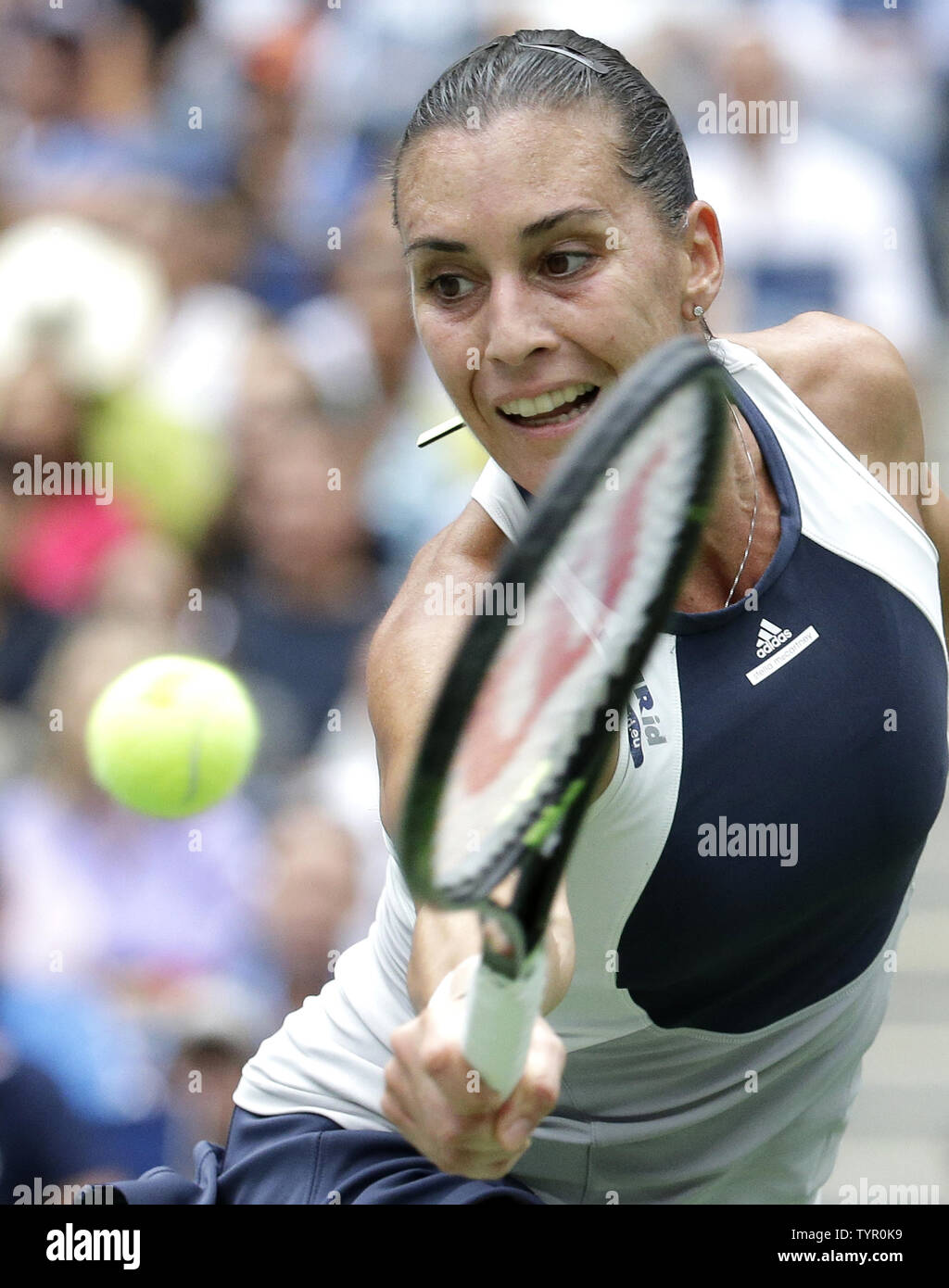 Flavia Pennetta of Italy hits a backhand to Roberta Vinci of Italy in the Women's Final in Arthur Ashe Stadium at the US Open Tennis Championships at the USTA Billie Jean King National Tennis Center in New York City on September 12, 2015. Pennetta wins the match 7-6, 6-2 becoming the first Italian women to win a US Open and also announced her retirement at the Trophy Ceremony.      Photo by John Angelillo/UPI Stock Photo