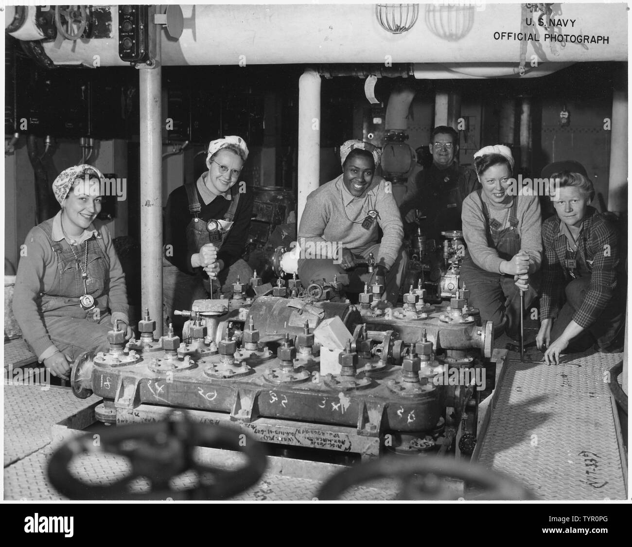 Women shipfitters worked on board the USS NEREUS, and are shown as they neared completion of the floor in a part of the engine room. Left to right are Shipfitters Betty Pierce, Lola Thomas, Margaret Houston Thelma Mort and Katie Stanfill. US Navy Yard, Mare Island,CA. Stock Photo