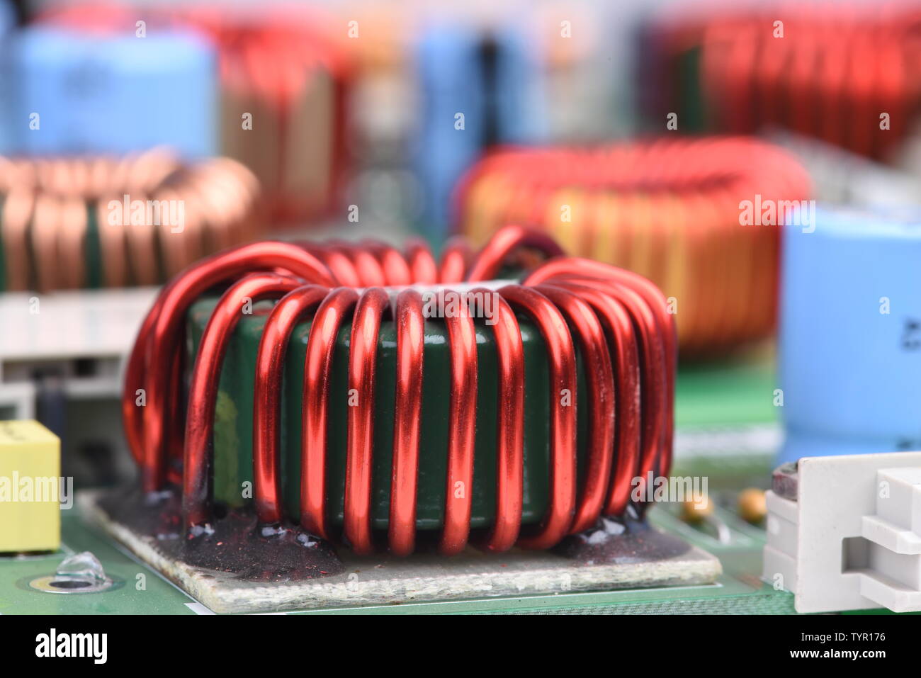 Copper coil, inductor on circuit board with blurred background Stock Photo