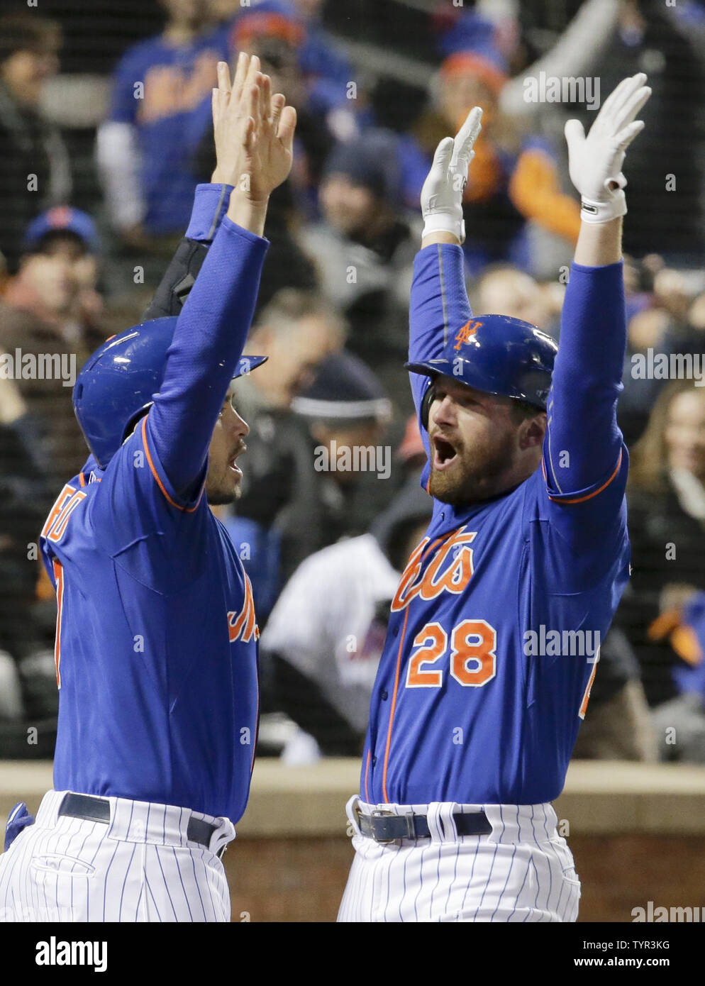 New York Mets batter Daniel Murphy (28) celebrates with on-deck batter Travis d'Arnaud at the dugout steps after he hit a solo home run against the Chicago Cubs in the first inning inning of game 1 of the NLCS at Citi Field in New York City on October 17, 2015.    Photo by Ray Stubblebine/UPI Stock Photo