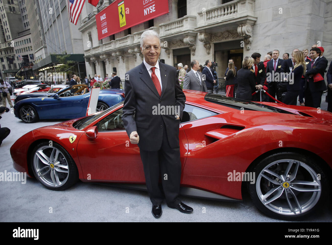 Piero Ferrari, son of Ferrari founder Enzo Ferrari, stands with a Ferrari outside of the NYSE after the opening bell on the first day of public trading of Ferrari at the New York Stock Exchange on Wall Street in New York City on October 21, 2015. The company's stock priced its initial public offering at $52 a share after the market close on Tuesday, with sources saying the demand for shares was 'well oversubscribed.' The price was at the top of the previously indicated range of $48 to $52 per share. Ferrari RACE shares were trading at $58.18 up almost 10 percent Wednesday in its debut on the N Stock Photo