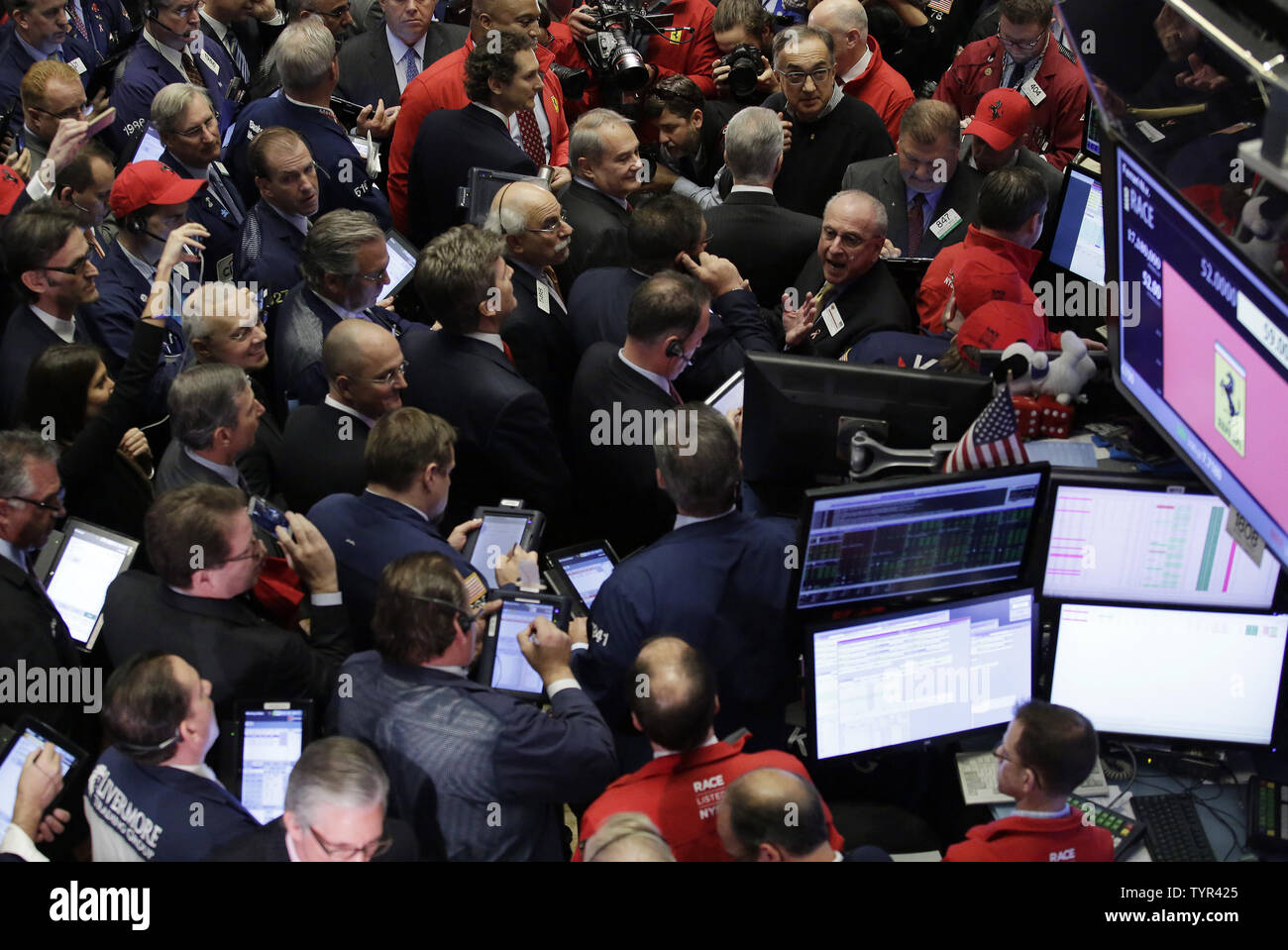 Traders work on the floor of the NYSE on the first day of public trading of  Ferrari at the New York Stock Exchange on Wall Street in New York City on  October