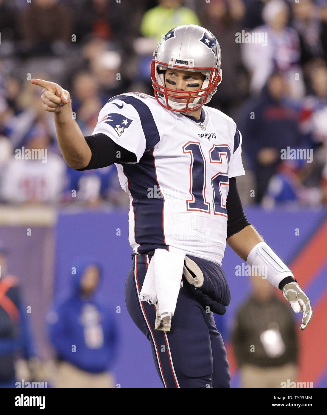 New England Patriots Tom Brady points to the sidelines after