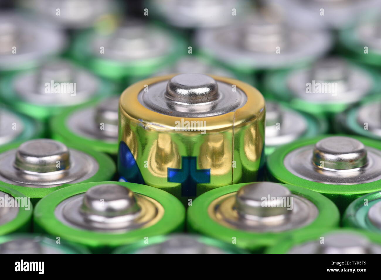 Macro of alkaline batteries with selective focus on single one with positive sign Stock Photo