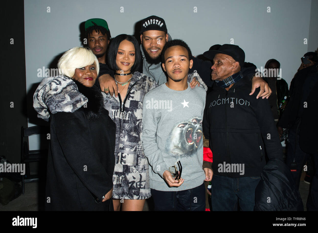 Rihanna poses with her family backstage after the FENTY PUMA by Rihanna  2016 Collection at 23 Wall Street during Fall 2016 New York Fashion Week on  February 12, 2016 in New York