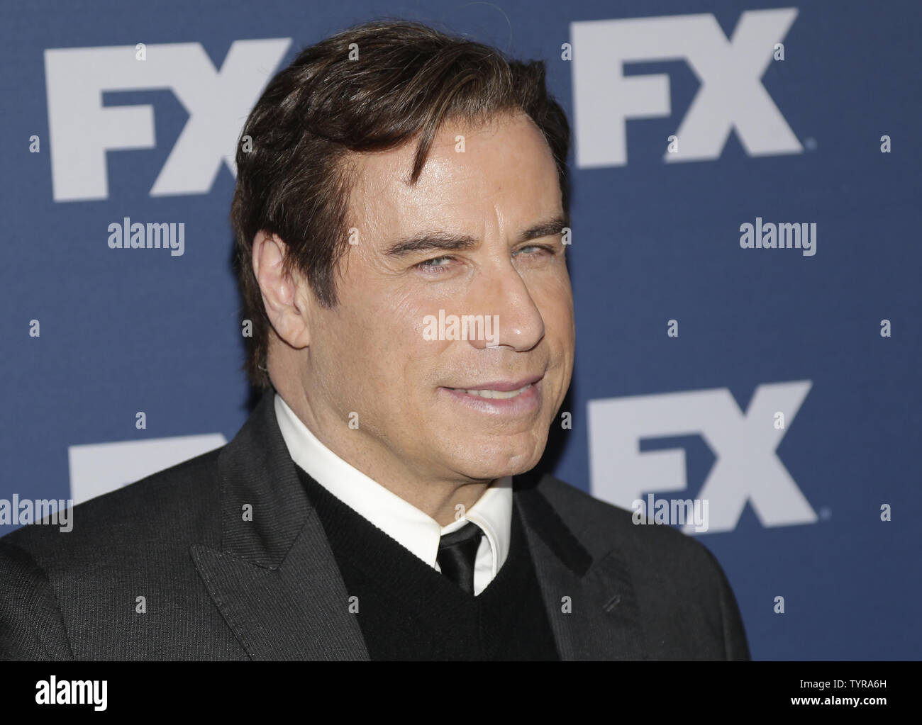 John Travolta arrives on the red carpet at the FX Networks upfront screening of 'The People v. O ...