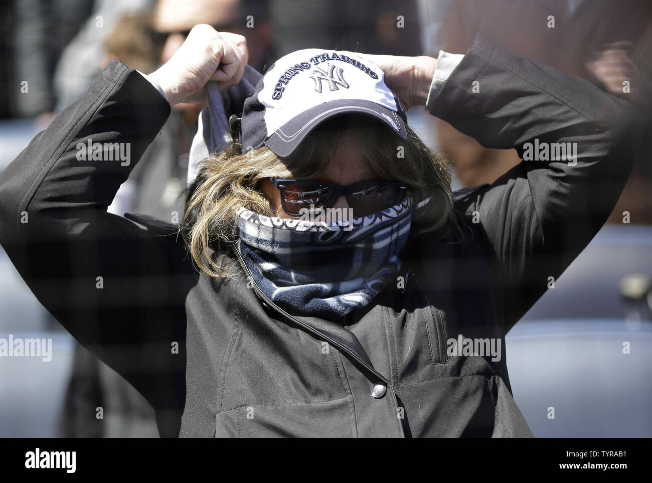 A girl wearing a Yankees spring training hat bundles up for cold weather  before the New York Yankees play the Houston Astros on Opening Day at Yankee  Stadium in New York City