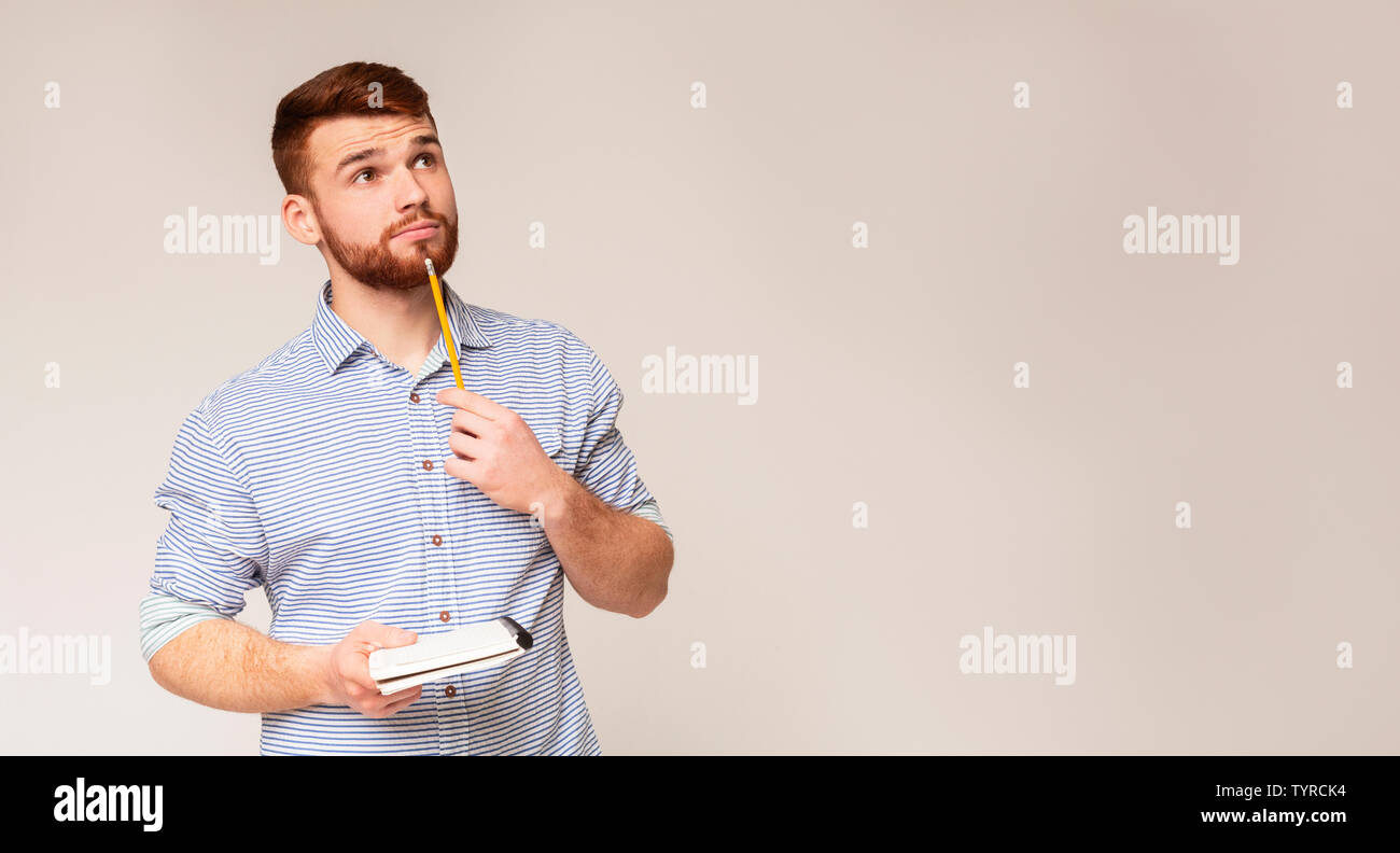 Young man thinking about checklist what to do Stock Photo