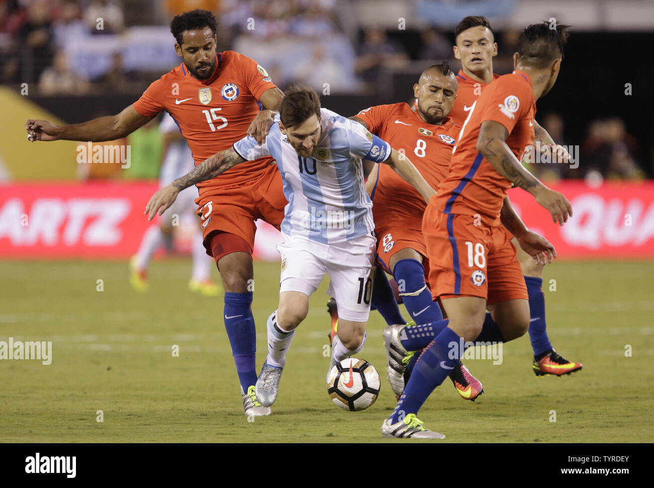 Chile Jean Beausejour holds Argentina Lionel Messi who eventually falls to the ground brining the ball to the goal at the Copa America Centenario USA 2016 Finals at MetLife Stadium in East Rutherford, New Jersey on June 26, 2016. Chile defeated Argentina 4-2 in penalty kicks and won there second consecutive Copa America.     Photo by John Angelillo/UPI Stock Photo