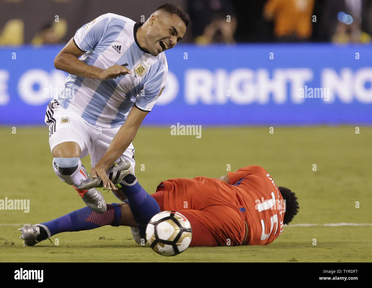 Argentina Gabriel Mercado trips over the leg of Chile Jean Beausejour at the Copa America Centenario USA 2016 Finals at MetLife Stadium in East Rutherford, New Jersey on June 26, 2016. Chile defeated Argentina 4-2 in penalty kicks and won there second consecutive Copa America.     Photo by John Angelillo/UPI Stock Photo
