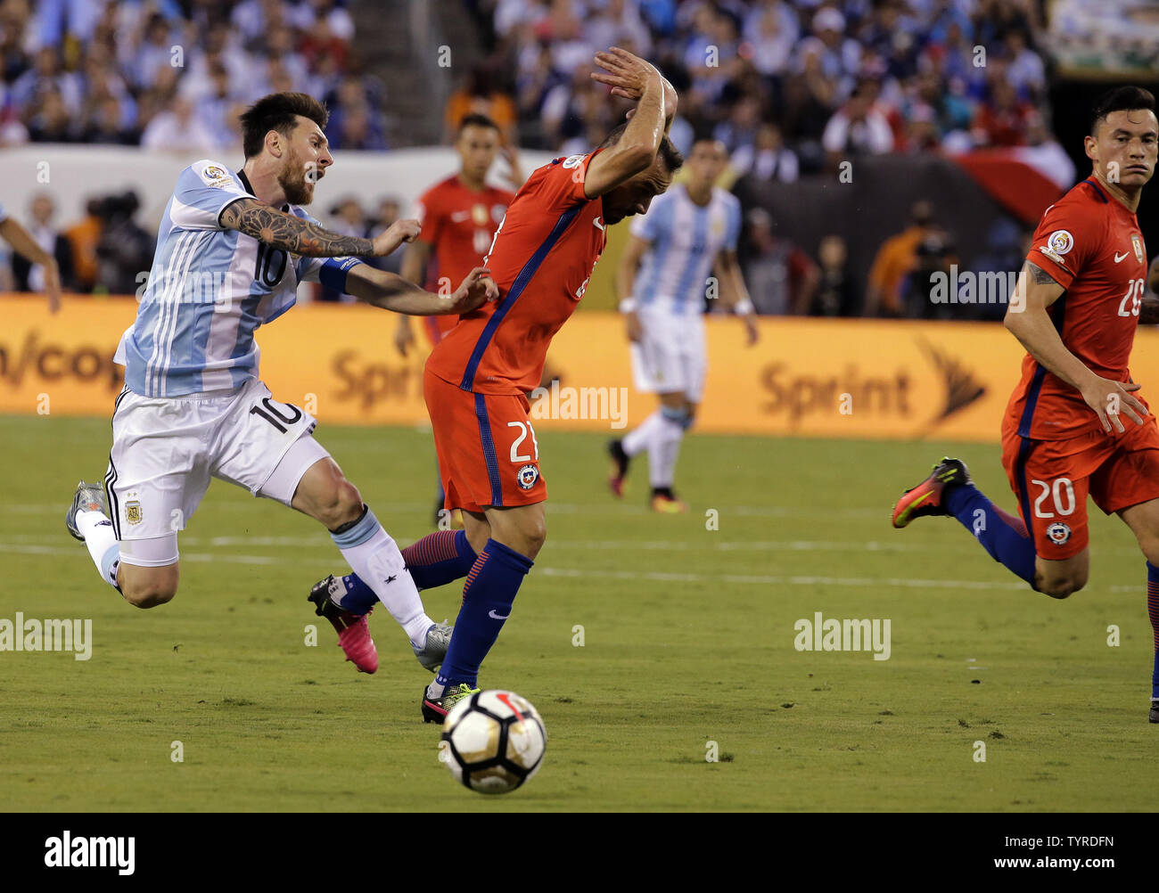 Argentina midfielder Lionel Messi (10) is fouled by Chile midfielder Marcelo Diaz (21) who draws his second yellow card and is ejected from the game as a result in the first half at the Copa America Centenario USA 2016 Finals at MetLife Stadium in East Rutherford, New Jersey, on June 26, 2016.      Photo by Ray Stubblebine/UPI Stock Photo