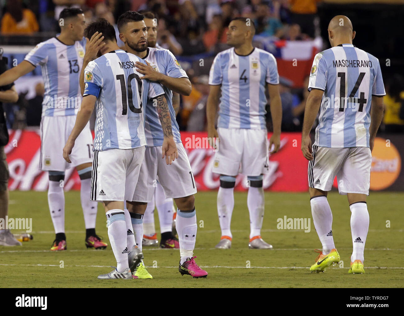 Argentina midfielder Lionel Messi (10) is consoled by forward Sergio Aguero (11) after he missed his shot in the penalty kicks phase at the Copa America Centenario USA 2016 Finals at MetLife Stadium in East Rutherford, New Jersey on June 26, 2016.  Chile won 4-2 in penalty kicks.    Photo by Ray Stubblebine/UPI Stock Photo