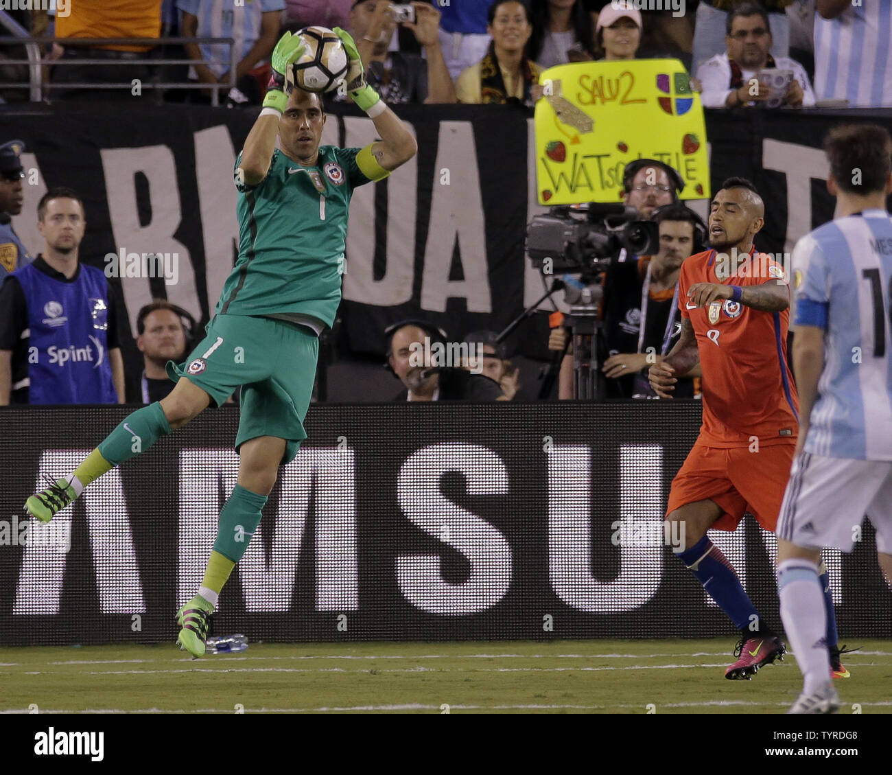 Chile goalkeeper Claudio Bravo (1) makes a save in front of Chile midfielder Arturo Vidal (8) and Argentina midfielder Lionel Messi (right) in overtime at the Copa America Centenario USA 2016 Finals at MetLife Stadium in East Rutherford, New Jersey on June 26, 2016.      Photo by Ray Stubblebine/UPI Stock Photo