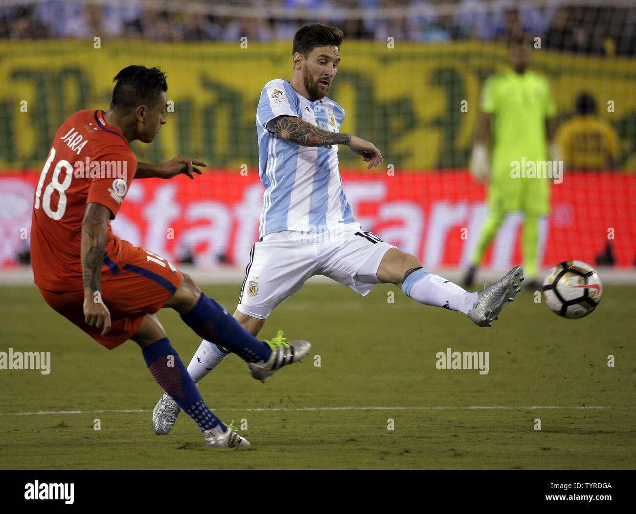 Argentina Midfielder Lionel Messi 10 Passes The Ball Around Chile Defender Gonzalo Jara 18 In The Second Half At The Copa America Centenario Usa 2016 Finals At Metlife Stadium In East Rutherford