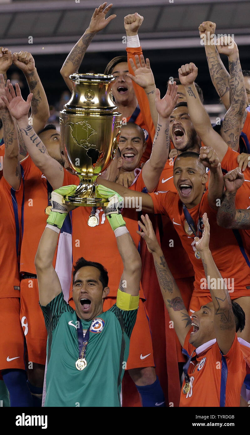 Chile goalkeeper Claudio Bravo (1) holds the cup as his teammates celebrate after beating Argentina in the penalty kicks phase at the Copa America Centenario USA 2016 Finals at MetLife Stadium in East Rutherford, New Jersey on June 26, 2016.      Photo by Ray Stubblebine/UPI Stock Photo