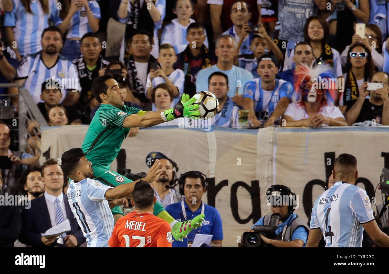 Chile goalkeeper Claudio Bravo (1) leaps above Argentina forward Sergio Aguero (11) and Chile defender Gary Medel (17) to make a save in the second half at the Copa America Centenario USA 2016 Finals at MetLife Stadium in East Rutherford, New Jersey on June 26, 2016.      Photo by Ray Stubblebine/UPI Stock Photo