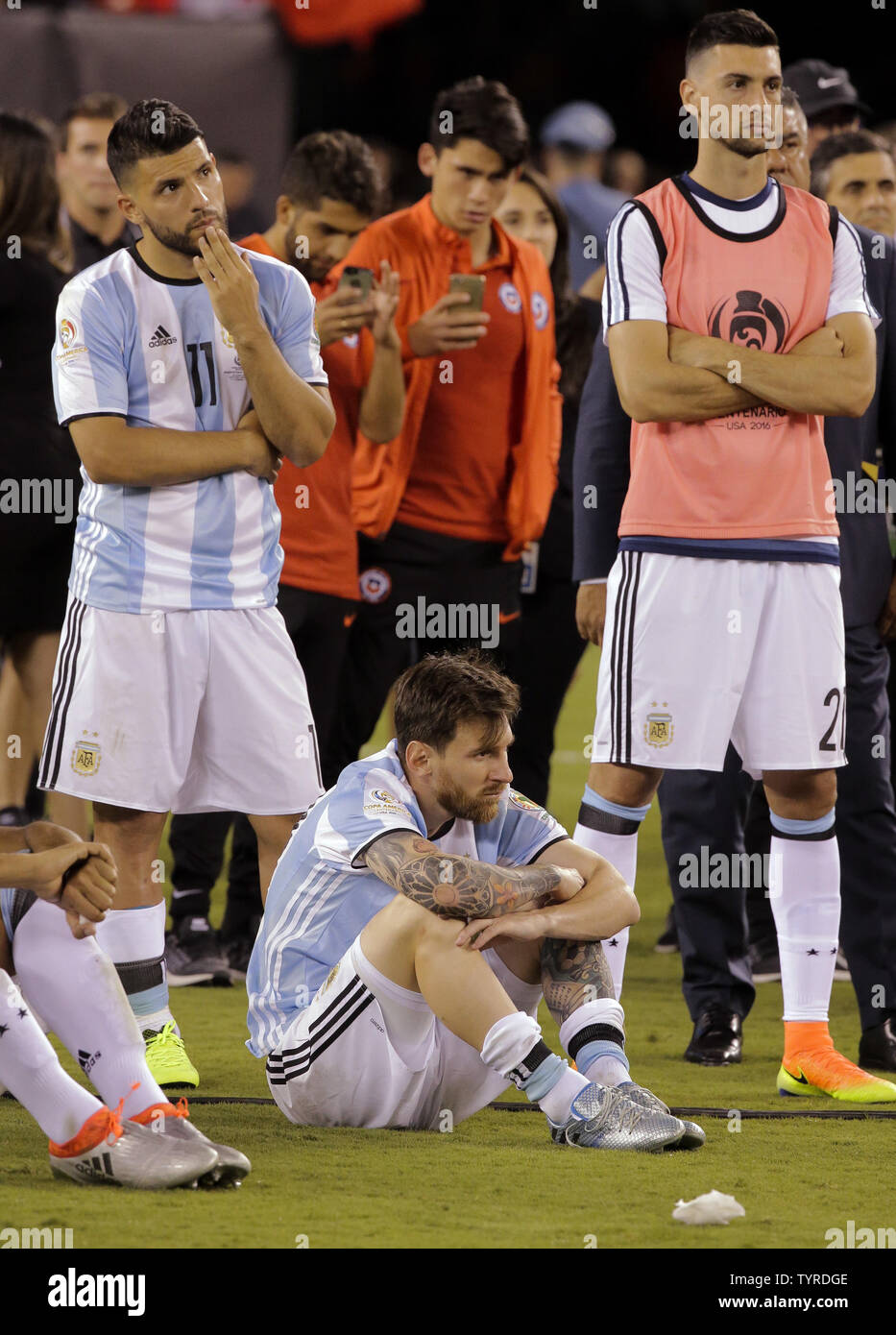 Argentina forward Sergio Aguero (11), midfielder Lionel Messi (10) and midfielder Javier Pastore (right) watch the awards ceremony after they lost the Copa America Centenario USA 2016 Finals to Chile 4-2 in penalty kicks at MetLife Stadium in East Rutherford, New Jersey on June 26, 2016.      Photo by Ray Stubblebine/UPI Stock Photo