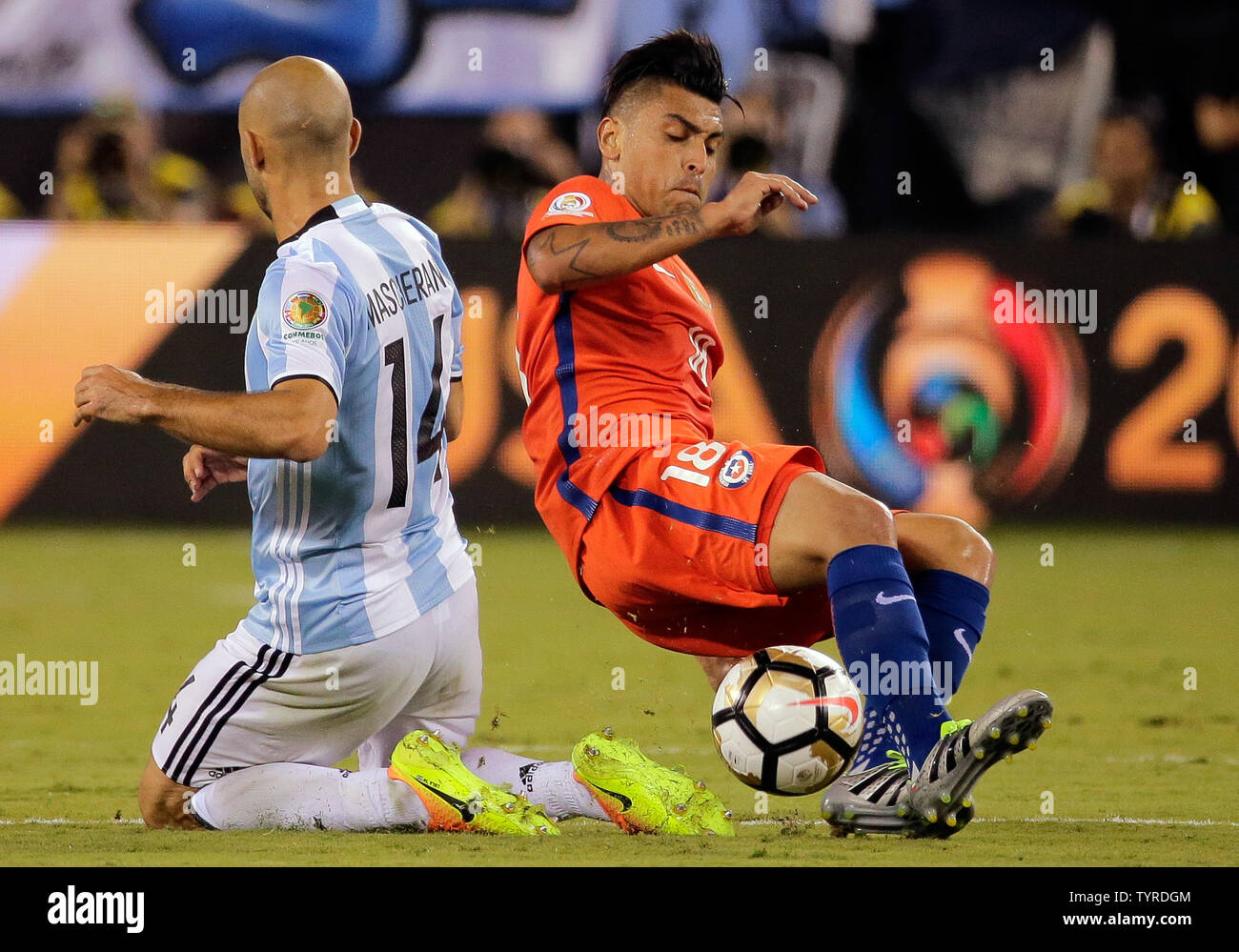 Chile defender Gonzalo Jara (18) steals the ball from Argentina midfielder Javier Mascherano (14) in overtime at the Copa America Centenario USA 2016 Finals at MetLife Stadium in East Rutherford, New Jersey on June 26, 2016.      Photo by Ray Stubblebine/UPI Stock Photo