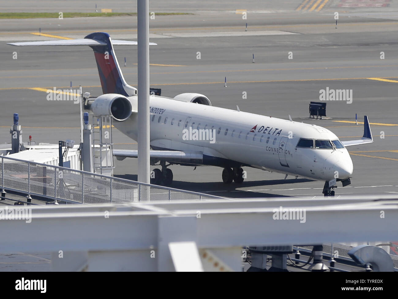 A Delta Airlines plane stands on the runway LaGuardia Airport in New York City on August 8, 2016 in New York City. Delta began to resume flights but still expect massive cancelations and delays after after a computer glitch shut down the airline completely this morning.    Photo by John Angelillo/UPI Stock Photo