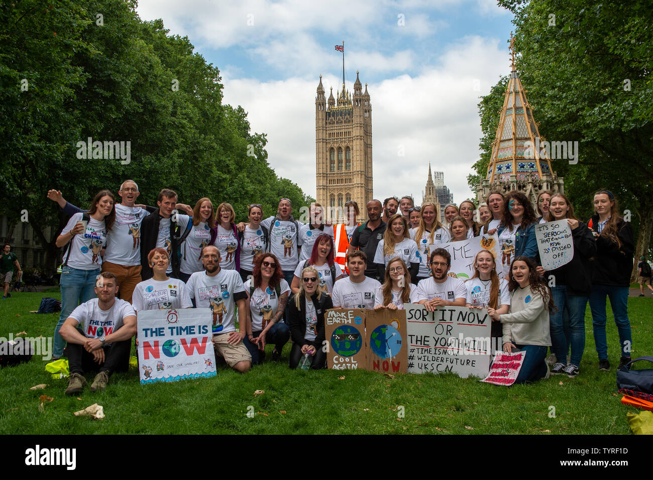 Victoria Tower Gardens, Westminster, London, UK. 26th June, 2019. Protestors pose for a photograph after the Time is Now Lobby. This was a mass lobby for climate, nature and people held around the streets in Westminster. Credit: Maureen McLean/Alamy Stock Photo