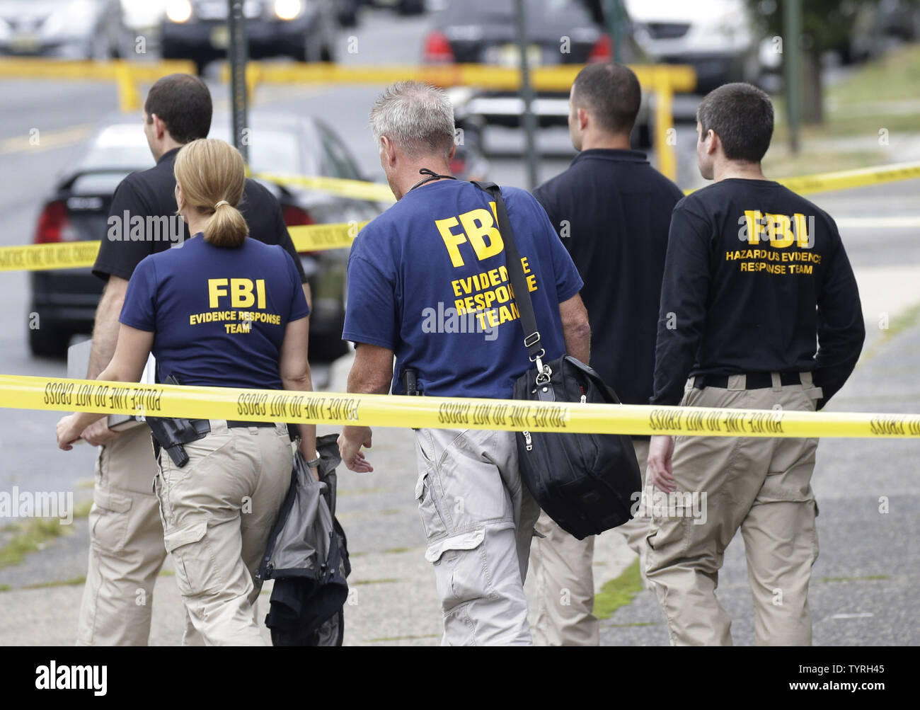 FBI investigators and police walk away from First American Fried Chicken after Ahmad Khan Rahami, the man responsible for the New York and New Jersey bombings, was apprehended by police on September 19, 2016 in Elizabeth, New Jersey. Two days before, an explosion from a bomb went off on West 23rd Street in Manhattan around 8:30 p.m. on Saturday, injuring 29 people on West 23rd Street in Manhattan. The man responsible for the explosion in Manhattan on Saturday night and an earlier bombing in New Jersey, Ahmad Khan Rahami, was taken into custody on Monday after he was wounded in a gunfight with Stock Photo