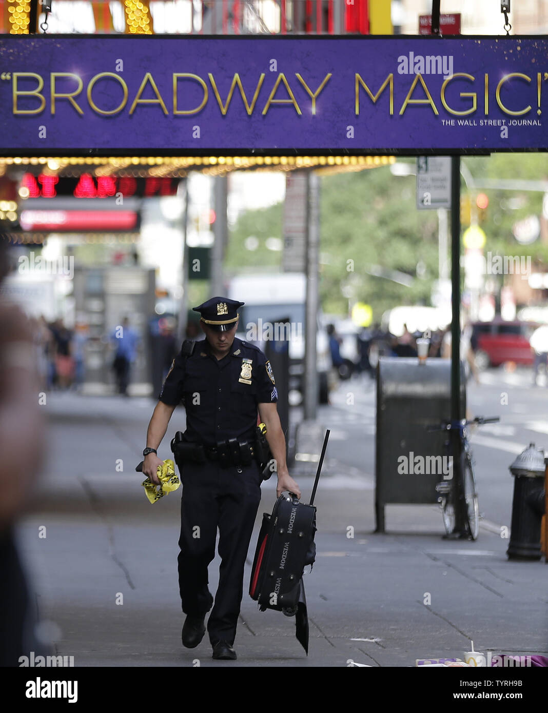 An NYPD Police Officer carries away a bag in Times Square after reports of a suspicious package sent police and the Bomb Squad to the scene on September 21, 2016 in New York City. The package turned out to be an empty suitcase and the all clear was given shortly after. Tensions are still high days after an explosion from a bomb went off on West 23rd Street in Manhattan on Saturday, injuring 29 people, shattering windows and prompting widespread street closures on West 23rd Street.      Photo by John Angelillo/UPI Stock Photo