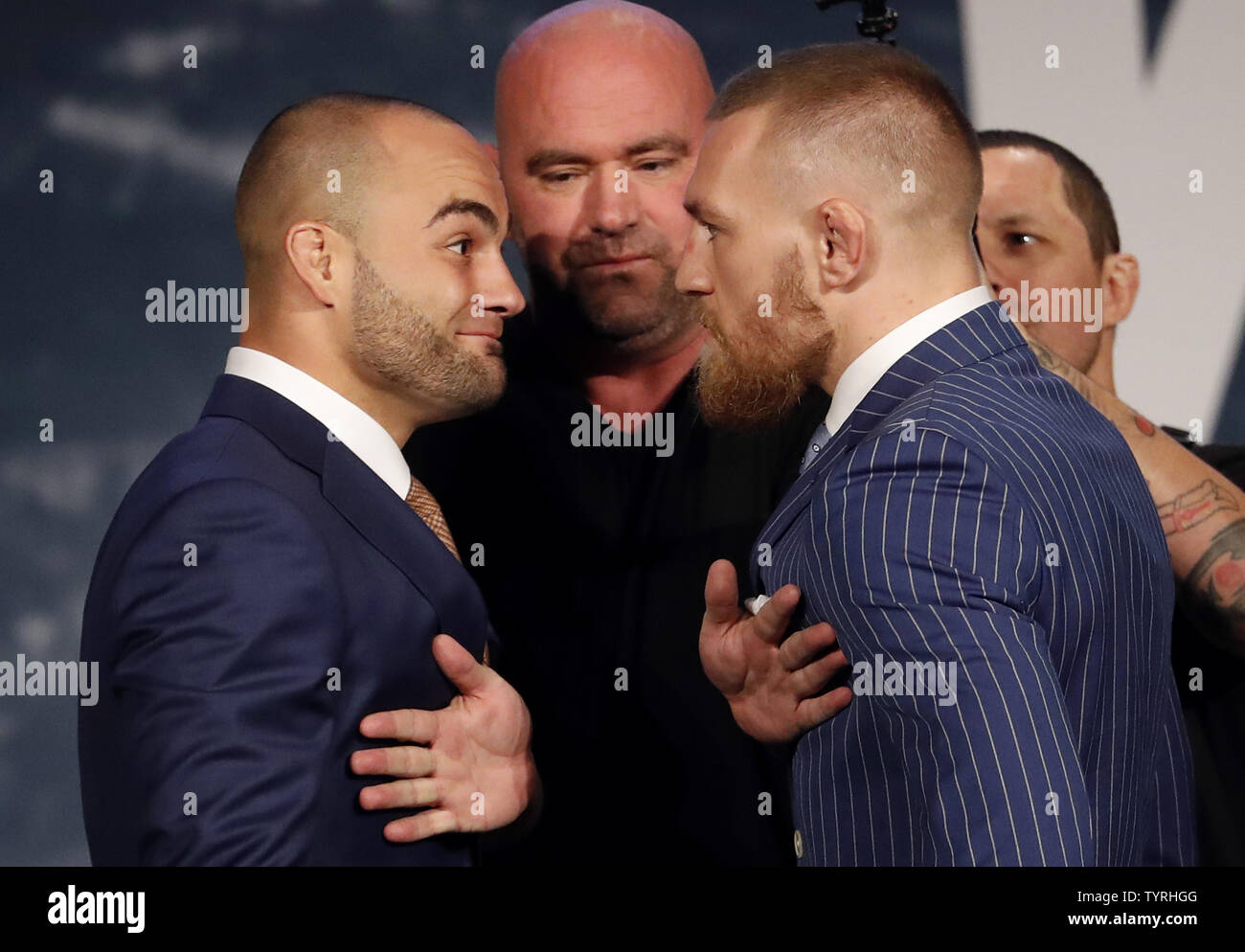 UFC president Dana White stands between UFC featherweight champion Conor  McGregor and UFC lightweight champion Eddie Alvarez when they face-off at  the UFC 205 press event at Madison Square Garden on September