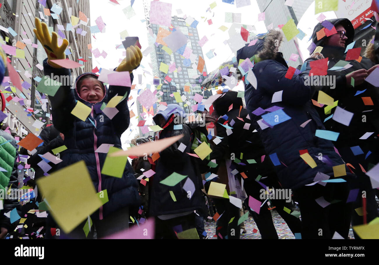 A girl catches confetti as it falls from the Hard Rock Cafe marquee as ...