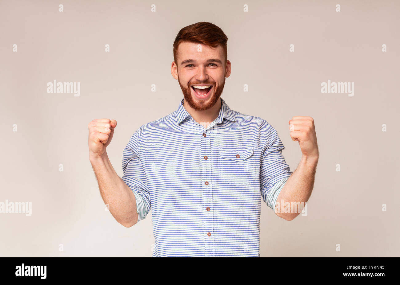 Cheerful guy showing his biceps and smiling Stock Photo